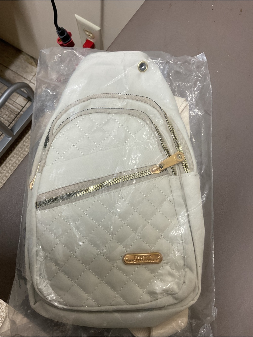 Quilted White Sling Backpack with Gold Hardware